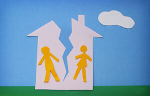 paper cutout couple in a split house - divorce concept