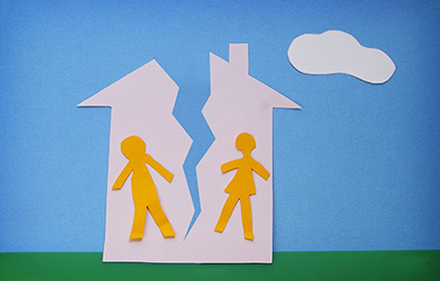 paper cutout couple in a split house - divorce concept