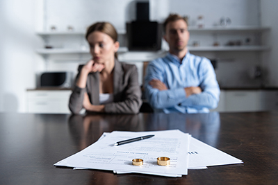 selective focus of couple sitting at table with divorce 