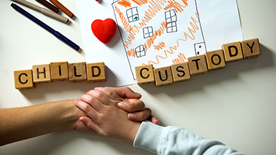 hild custody phrase and toy heart on house picture, kid holding mother hand